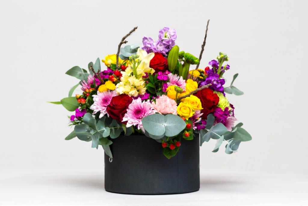 A colourful franjipanji hat box arrangement