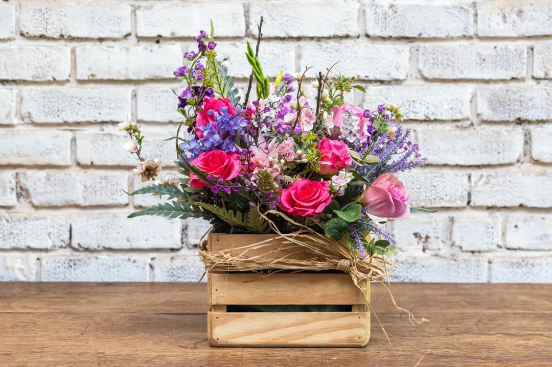 Pink garden artificial flower crate arrangement