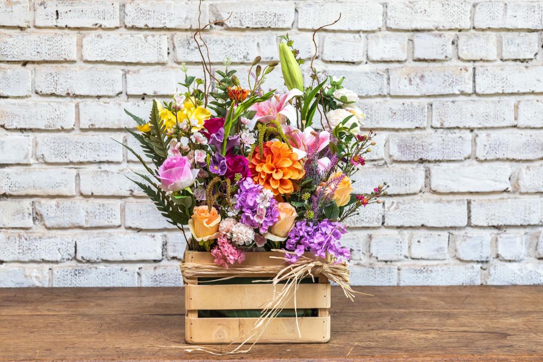 Mixed artificial flower crate arrangement front view