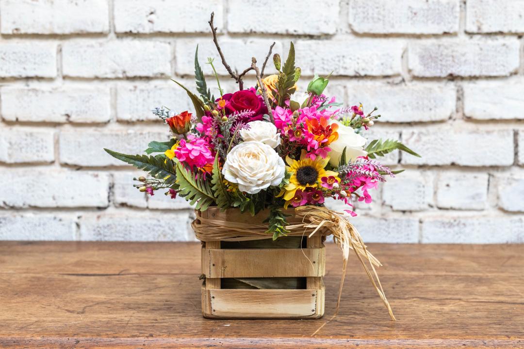 Mixed artificial flower crate arrangement detail