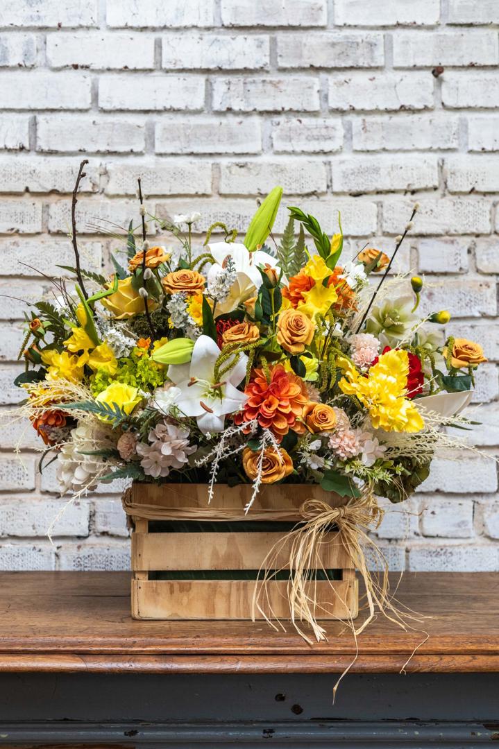Yellow garden artificial flower crate arrangement