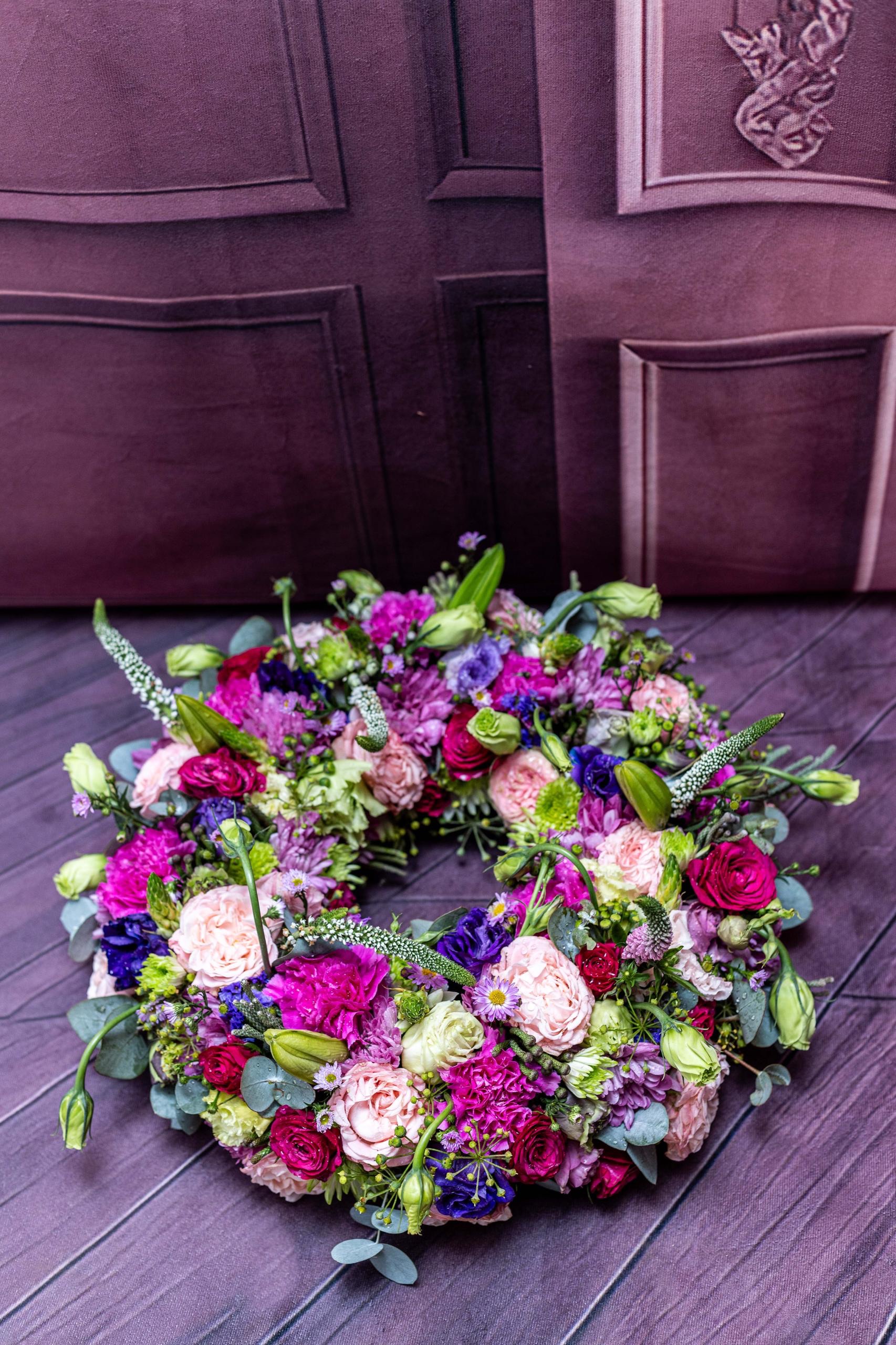 Pink, purple, and green fresh flower wreath